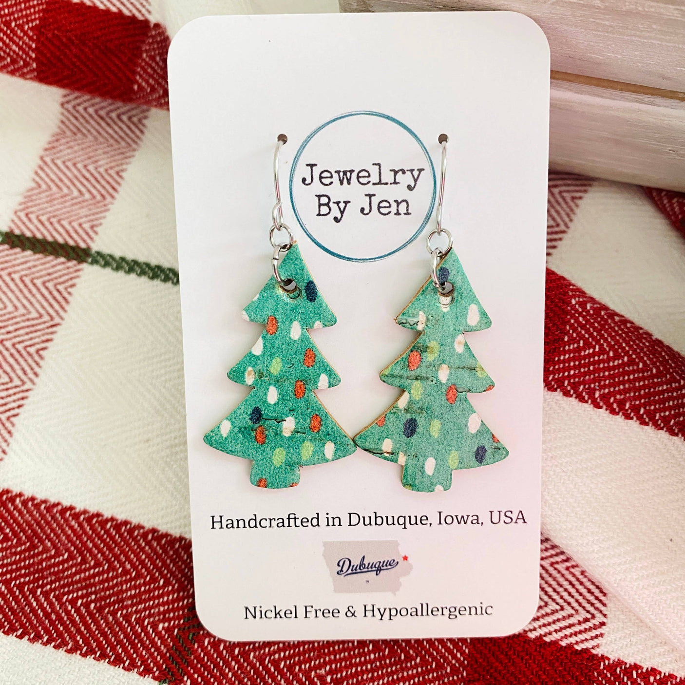 A pair of green Christmas tree earrings with dots, displayed on a card with 'Jewelry by Jen' branding.