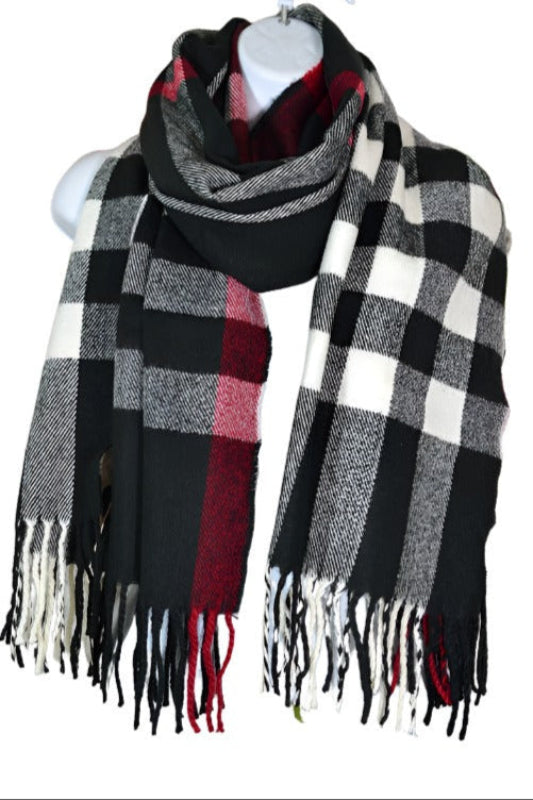A black, white, and red buffalo plaid fringe scarf displayed on a mannequin.